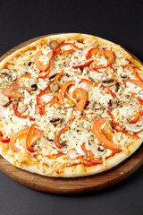 Hot pizza Con Fattoria on a rustic wooden table.