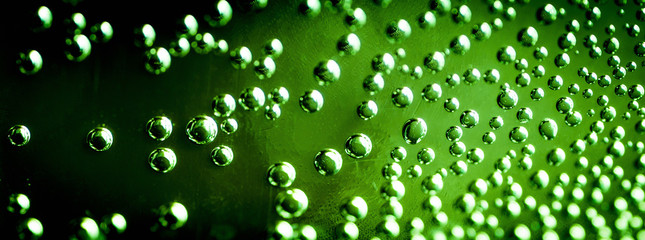 Air bubbles on the wall of the plastic bottle with water close-up as a background.
