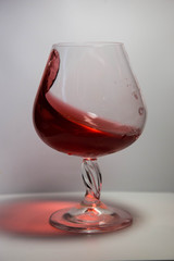 A glass of red wine in motion
