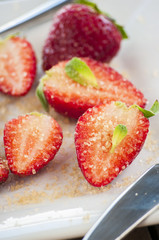 strawberries cut with sugar and mint