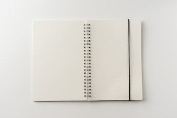 Business concept - Top view of spiral blank notebook on white background desk for mockup