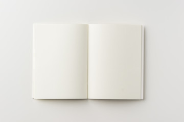Business concept - Top view of blank notebook on white background desk for mockup - obrazy, fototapety, plakaty