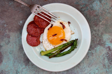 Fried eggs with bacon and asparagus. Rustic breakfast