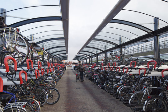 bikes parked at a train station in the netherlands