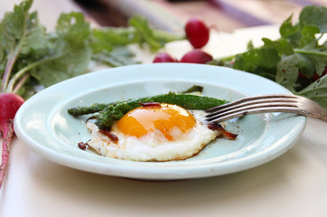 Fried eggs with bacon and asparagus. Rustic breakfast