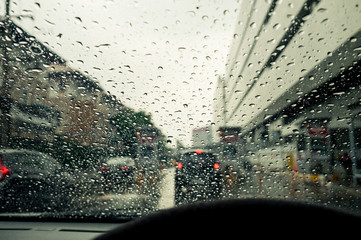 Windshield wipers from inside of car, season rain.