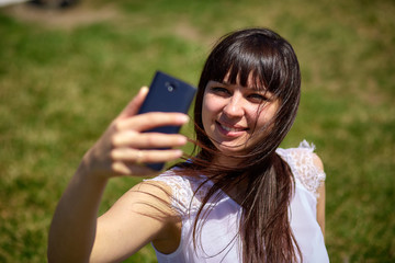 Beautiful oriental-looking girl doing selfie on a smartphone