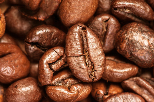 Coffee beans macro on a brown background
