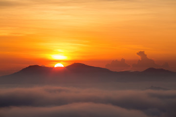 Landscape with sunrise over the mountain,misty morning in Thailand.