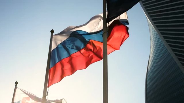 Close-up shot of flag of Russia in the wind on the background of Moscow City. HD