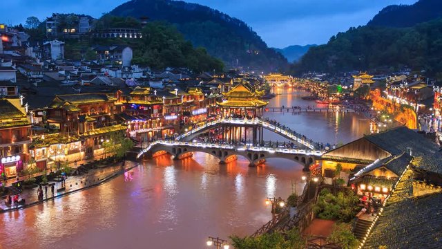 Fenghuang County Beautiful Ancient Town Of Hunan Province, China 4K Day To Night Time Lapse (zoom out)
