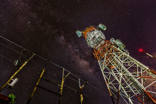 Telecommunication towers for mobile communications and TV antennas in the starry night with noise and grain,color tone.