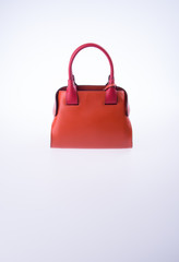 bag or brown leather woman handbag on background.