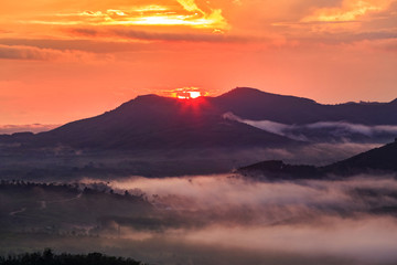 Landscape with sunrise over the mountain,misty morning in Thailand.