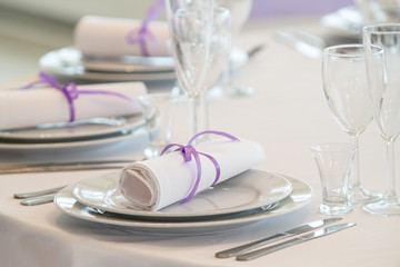 Table setting in a restaurant with napkins and glasses