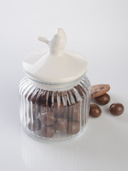 jar or glass jar with chocolate ball on the background.
