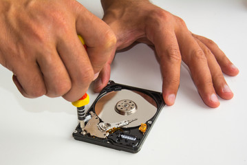 Repair hard disc drive using screwdriver