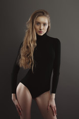 Fototapeta premium Model test with glamorous pretty model with lush blonde hair on grey background