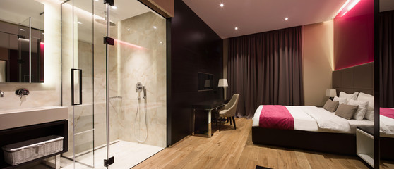 Interior of a hotel bedroom with bathroom