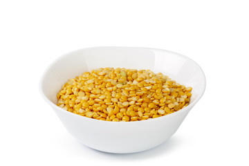 Dry yellow split peas isolated on white.