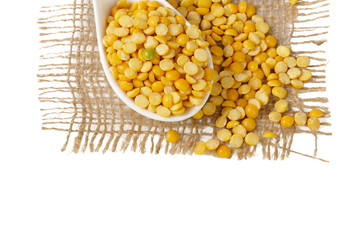 Dry yellow split peas isolated on white.