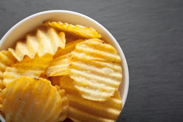 Potato chips in bowl on a table