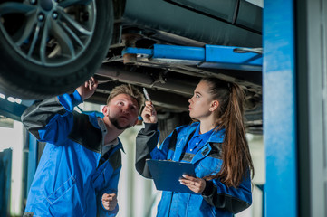 Man and woman in auto mechanics