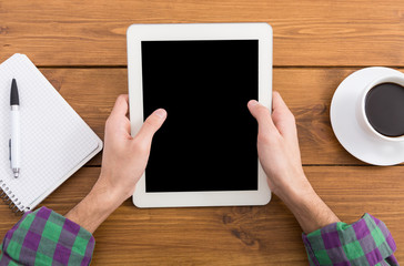 Man using tablet in coffee shop, close-up