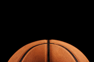 Close-up view of traditional basketball ball isolated on black background