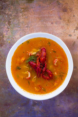 Crayfish soup on a vintage background with space for text.