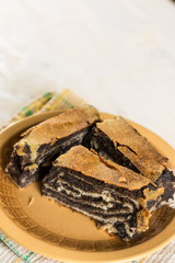 Poppy seed roll cake with copy space over wooden background