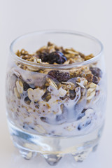 Granola with yogurt in glass cup