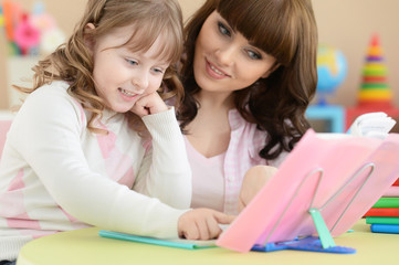 Fototapeta premium Mother and daughter doing lessons 