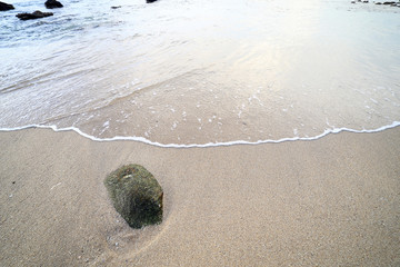 Rock and wave on the Ao Sen beach Phuket Thailand