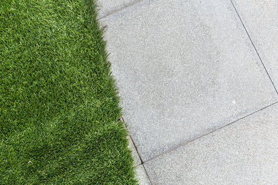 green grass with concrete background