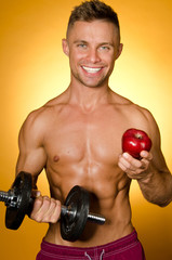 Fototapeta na wymiar Sport and healthy eating. Attractive guy in the gym.