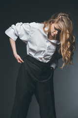 woman standing and posing on black