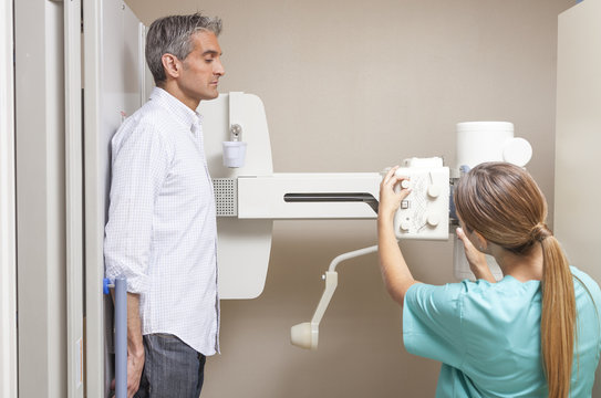 Female doctor with patient at scan machine in hospital
