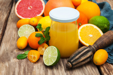 Jar of juice and fresh citrus fruits