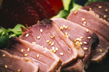 Taditional tuna tataki dish with stramberry, canon and sesame sauce
