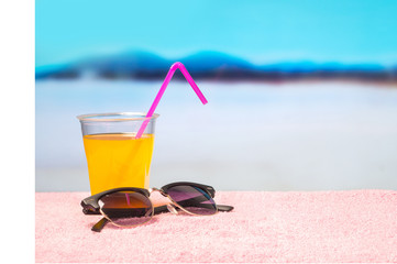 Paradise holiday background with yellow cocktail on sunglasses on beach. Perfect for summer sales and offer campaign promotion. Beautiful holiday paradise vibe with copy space for content and text.