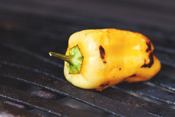 One yellow bell pepper on grill. Copy space