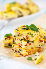 Homemade vegetarian rice frittata with zucchini, bell pepper and olives