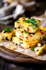 Homemade vegetarian rice frittata with zucchini, bell pepper and olives