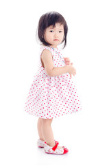 Little asian girl standing over white background
