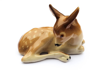 Beautiful porcelain figure of a little doe isolated on white background 