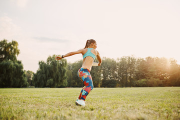 Young athletic girl playing with flying disc in the park. Professional player. Sport concept