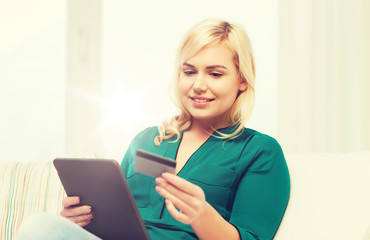 happy woman with tablet pc and credit card