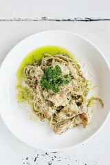 italian food chicken and cheese spaghetti with pesto sauce