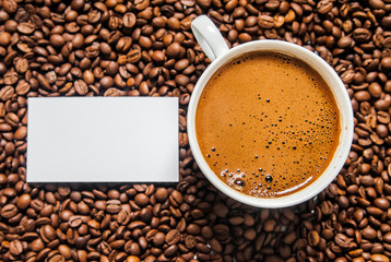 Coffee cup and coffee beans on table, top view, love coffee, Brown coffee beans isolated on white background, Hot Coffee cup with Coffee beans